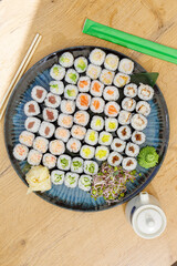 Large platter of assorted maki sushi rolls on a table © Cavan