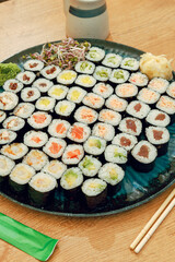 A large platter of assorted sushi maki rolls on a table © Cavan