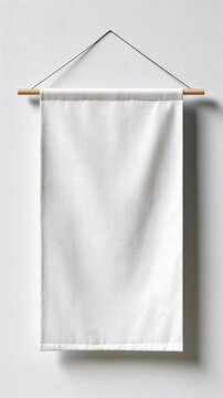 White fabric banner hanging on a wooden dowel against a wall