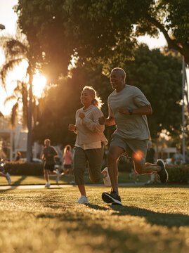 Active Senior Couple Running in Autumn Park &ndash; AI Generative