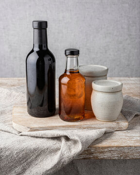 Rustic Kitchen Still Life with Bottles and Ceramic Jars