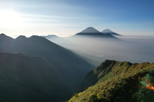 Majestic Sunrise Over Volcanic Mountain Range in Mist