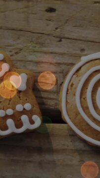 Animation of christmas gingerbread cookies on wooden background