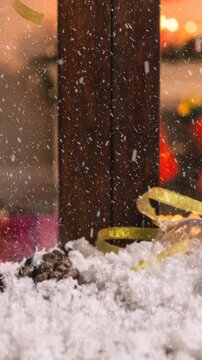 Animation of christmas tree seen through window with snow falling