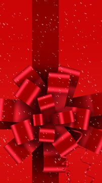 Animation of red christmas present ribbon with snow falling on red