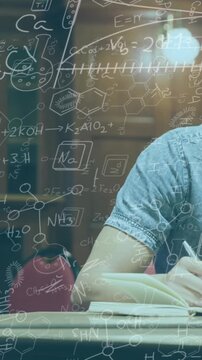 Digital composition of chemical structures floating against college student writing notes in library