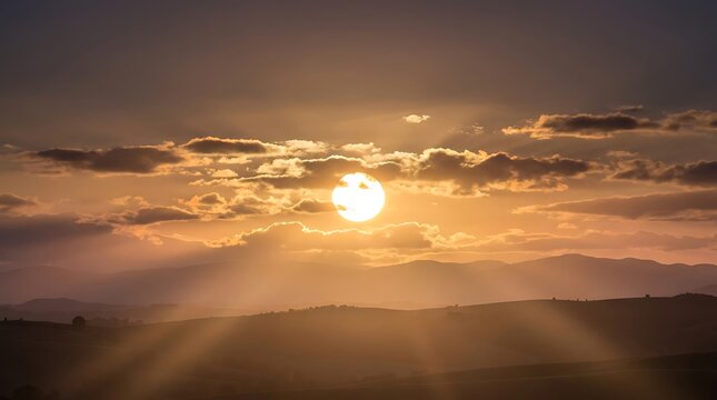 A breathtaking golden hour sunset casting dramatic light rays over a peaceful rolling landscape.