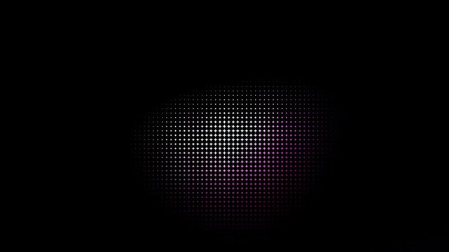 Abstract circular halftone pattern with colorful glowing light effect on a black background