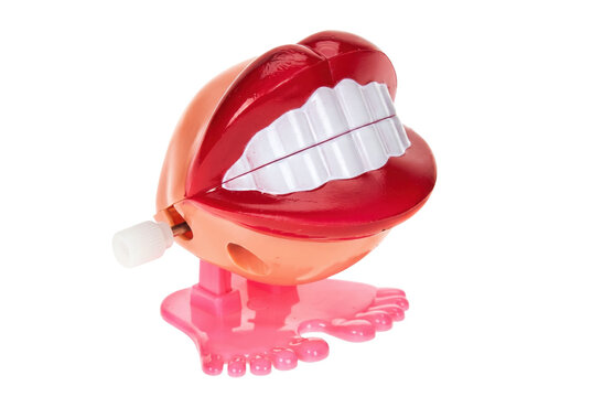 Wind up chattering teeth toy with red lips and pink feet