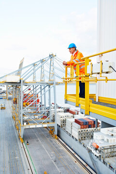 Man, logistics and manager on commercial dock, service overview and international courier. Male supervisor, thinking and space with inspection of freight loading bay at shipping port for export