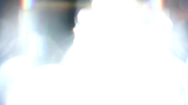 Abstract bright white light glowing and shimmering motion background.