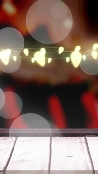 Animation of spots of light over christmas fairy lights decorations