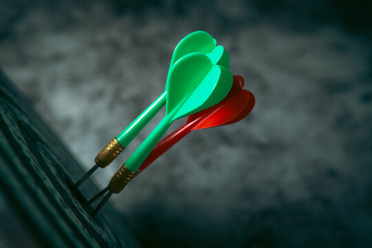 Green and red darts on a dark background. Business concept.