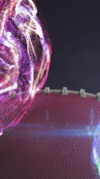 Animation of lens flare and multicolored abstract pattern over rugby ball against black background