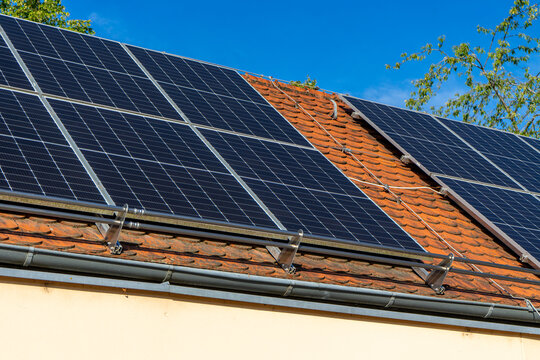 Solar Panels on a House Roof &ndash; Renewable Energy and Sustainable Home Power Concept