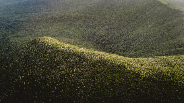 An aerial view of dense green forest mountains, Carrabassett, Maine