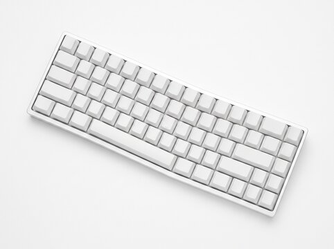 A white mechanical keyboard with blank keycaps on a white background.