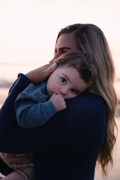 Baby boy resting on his mother's shoulder