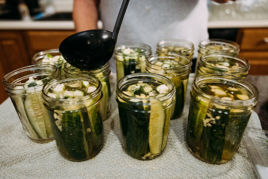 Woman making easy refigerator dill pickels