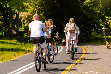 Fototapeta premium Cyclists ride on the bike path in the city Park 