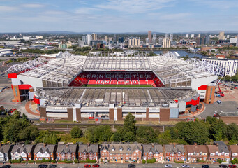Fototapeta premium Old Trafford football stadium and Salford Quays in Greater Manchester, England, seen from above with the surrounding urban landscape.