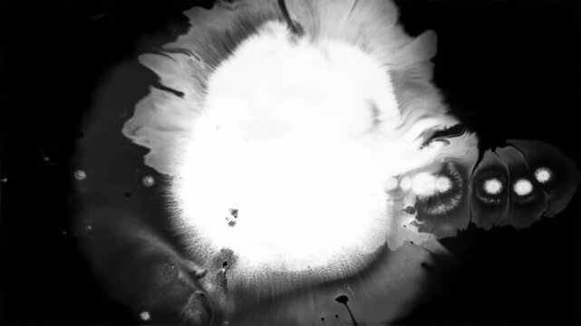 Abstract ink diffusion in water creating a bright glowing explosion effect.