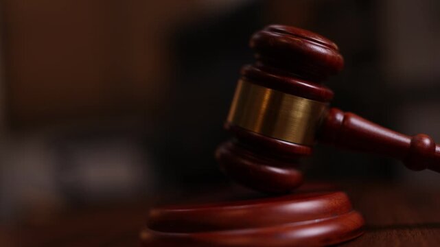 Justice hammer decision on a bench in a court room setting. 