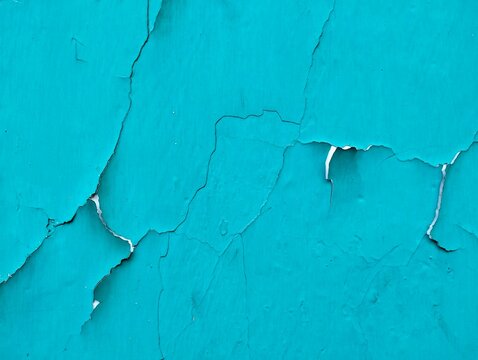 Abstract blue weathered background, cracked teal paint texture on concrete surface
