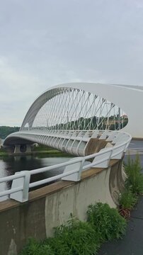 Vertical view of the bowstring arch of Troja Bridge spanning the Vltava River in Prague.