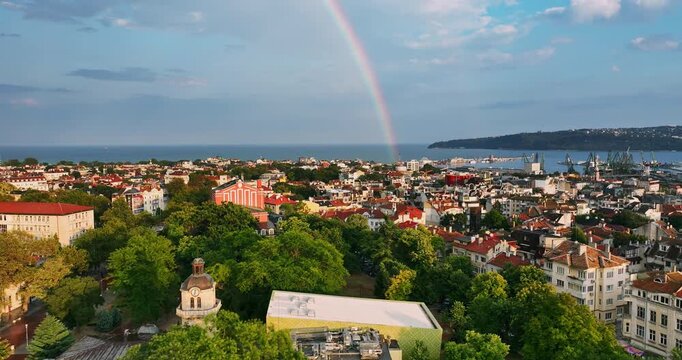 Panoramic aerial drone video of Verna and city landmarks in the downtown with double rainbow in sky, Bulgarian black sea coast
