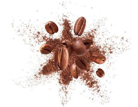 Flying roasted coffee beans with explosion of coffee powder isolated on a transparent background