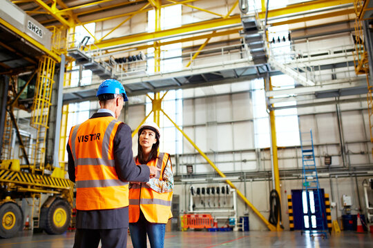 Man, woman or discussion in warehouse for export, distribution planning or problem solving. Worker, engineer or talk in logistics facility for compliance inspection, import control or expansion ideas