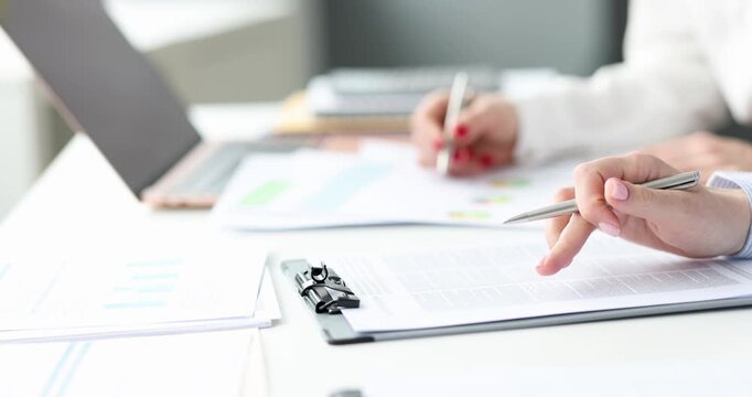 In a sunlit office, hands move with purpose over documents, highlighting charts and notes. Ideas flow during thoughtful discussions, showcasing collaboration and engagement.