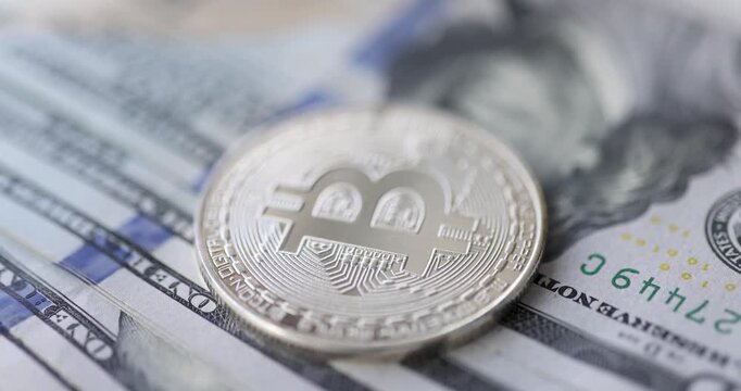 In this engaging visual journey, shiny bitcoin coins rest atop crumpled dollar bills, showcasing the fascinating interplay of traditional and digital currencies in a bustling marketplace.