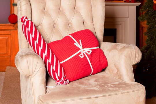 Cozy armchair with festive Christmas gifts and decorations indoors