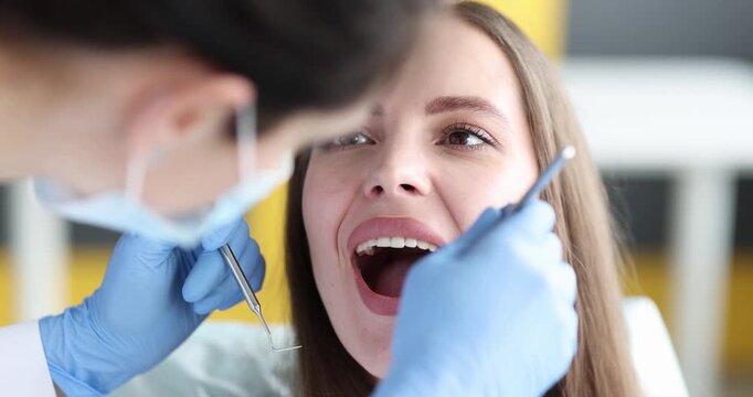 In a lively dental clinic, a cheerful patient enjoys her check-up with a friendly dentist. Tools glimmer as the doctor carefully examines her teeth and gums, ensuring her bright smile.
