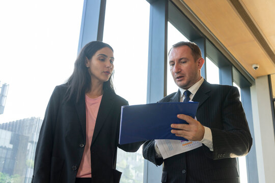 Businessman and businesswoman having a heated argument in a bright office. Business people concept.