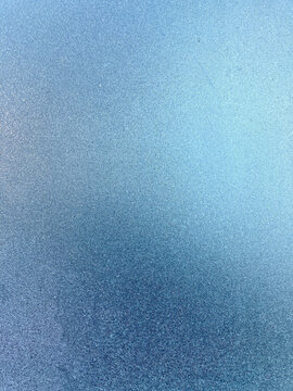 abstract macro photograph of frosted glass, showing a fine, granular texture of ice crystals.