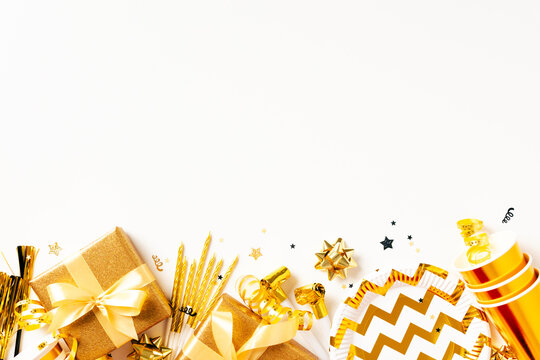 Golden birthday gifts and party supplies bottom border on white