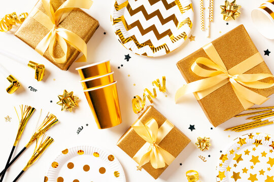 Golden party gifts and festive decorations pattern on white background