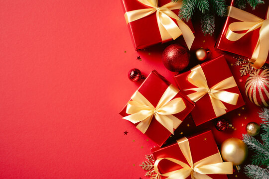Christmas red gift boxes with fir branches side border on red background