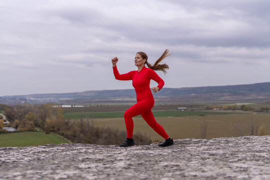 Mountain summit fitness challenge featuring an athletic woman running across a rocky trail