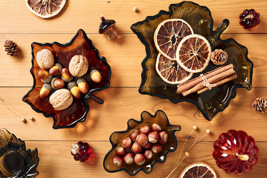 Autumn background with leaf shaped glass bowls on wooden table