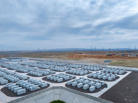 Large scale outdoor energy storage power station with neatly arranged battery modules under cloudy sky