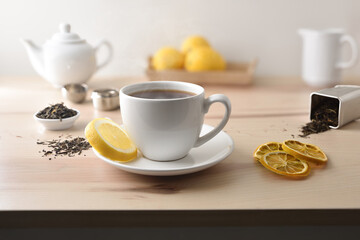 Fototapeta premium Hot tea on table with lemon tea and kitchen items
