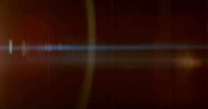 Slow motion of lens flare isolated on black background. Anamorphic lens. Cinematic glowing light overlay with optical streaks and rays for VFX compositing and transitions.
