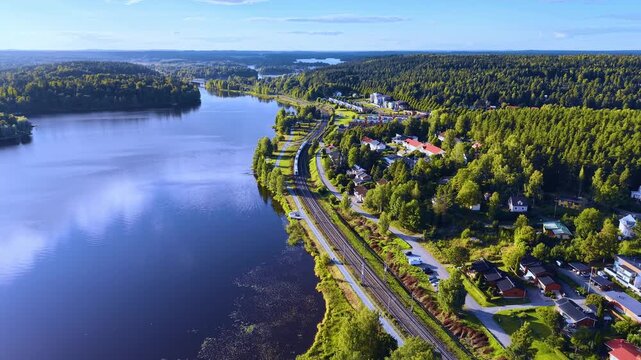 Aerial view of the train runs along the coast of Vanajavesi in a town called H&auml;meenlinna in Finland.