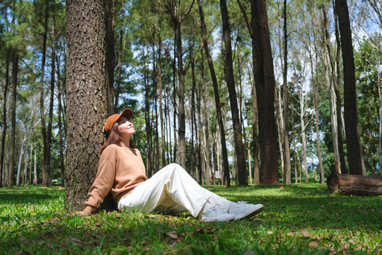 Portrait image of a woman sitting and relaxing in the park