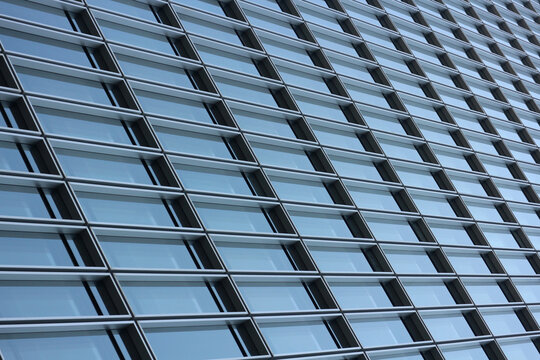 Modern glass facade pattern of corporate office building skyscraper, blue glass windows background with abstract architectural geometric line symmetry, Ho Chi Minh City, Vietnam