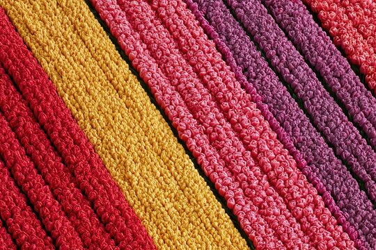 Vibrant Diagonal Stripes of Textured Fabric in Red, Yellow, Pink, Purple, and Orange Hues